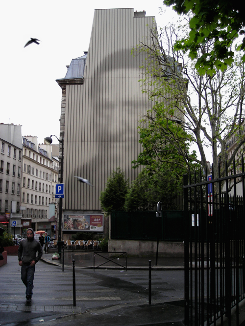 man on and next to building